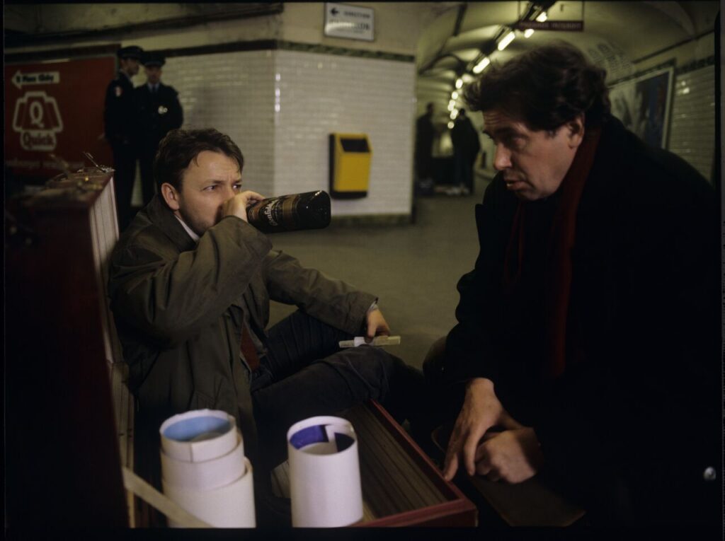 Karol (Zbigniew Zamachowski) and Mikołaj (Janusz Gajos) drink Bruderszaft on the Paris metro.