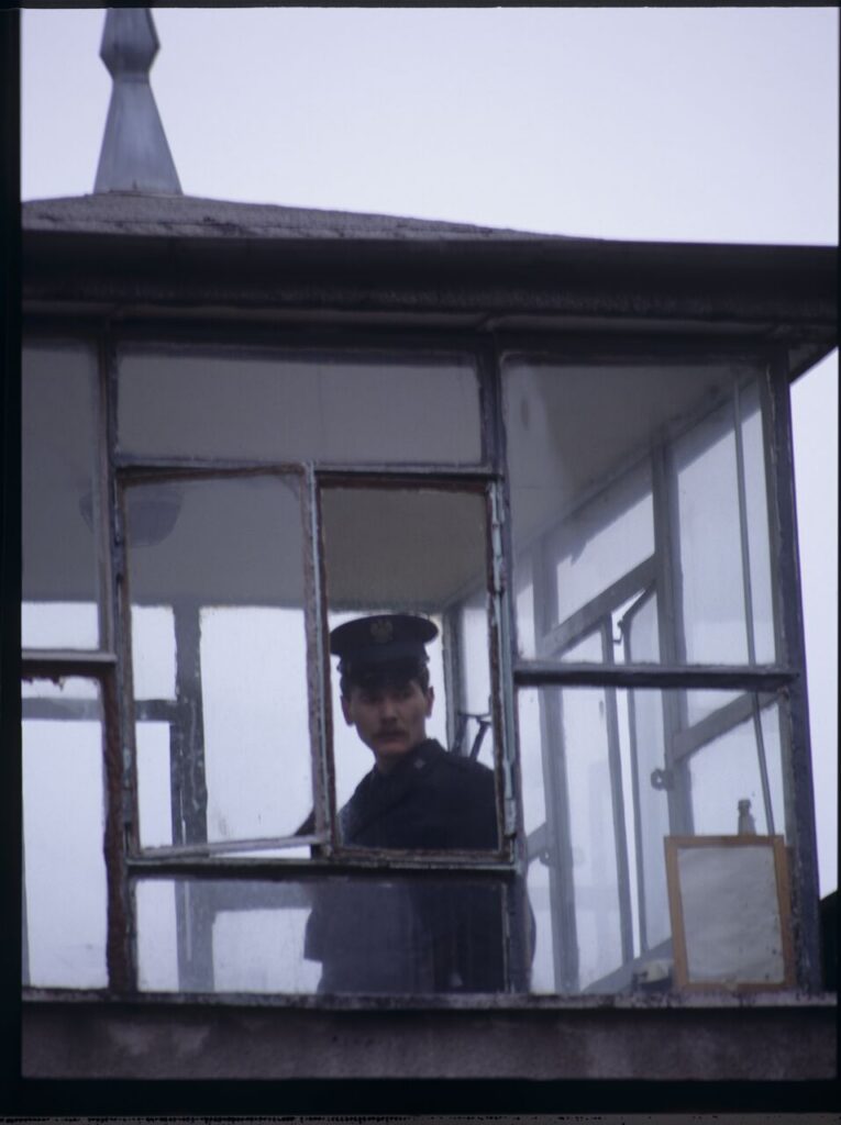 A guard in the watchtower of the prison where Karol's wife, Dominique, is serving her sentence.