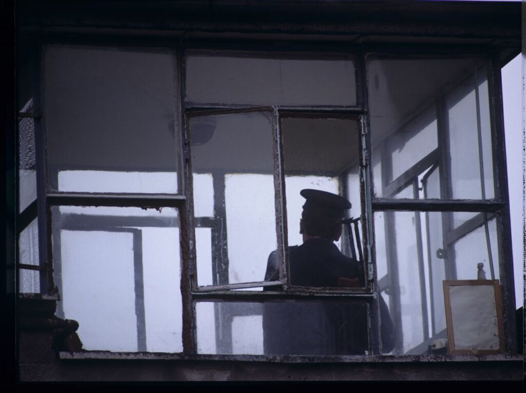 A guard in the watchtower of the prison where Karol's wife, Dominique, is serving her sentence.