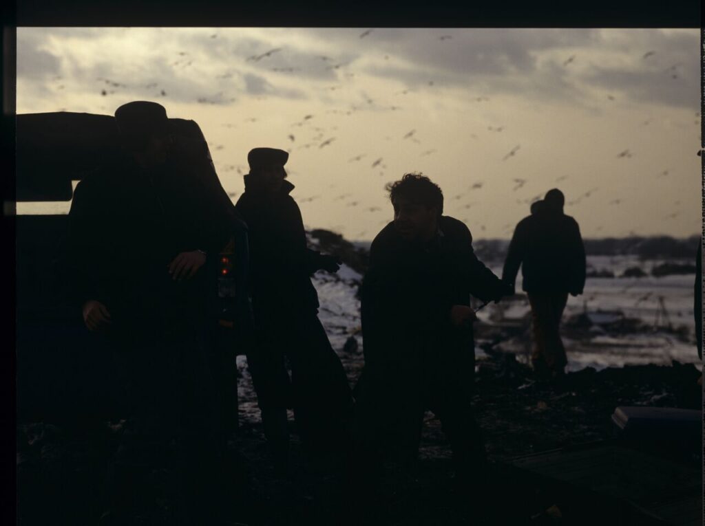 Shooting a scene at a garbage dump where airport luggage thieves bring a suitcase containing Karol.