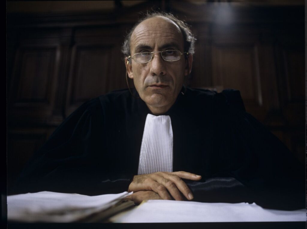 The judge (Philippe Morier Genoud) during Charles and Dominique's divorce case.