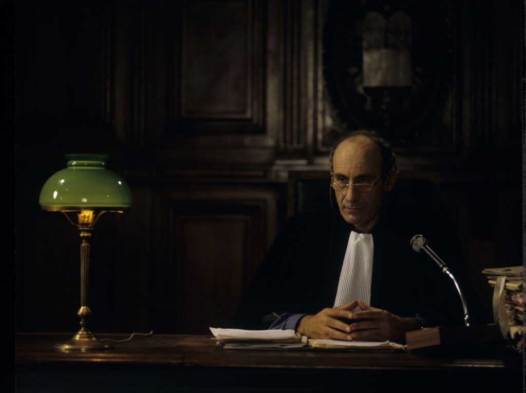 The judge (Philippe Morier Genoud) during Charles and Dominique's divorce case.