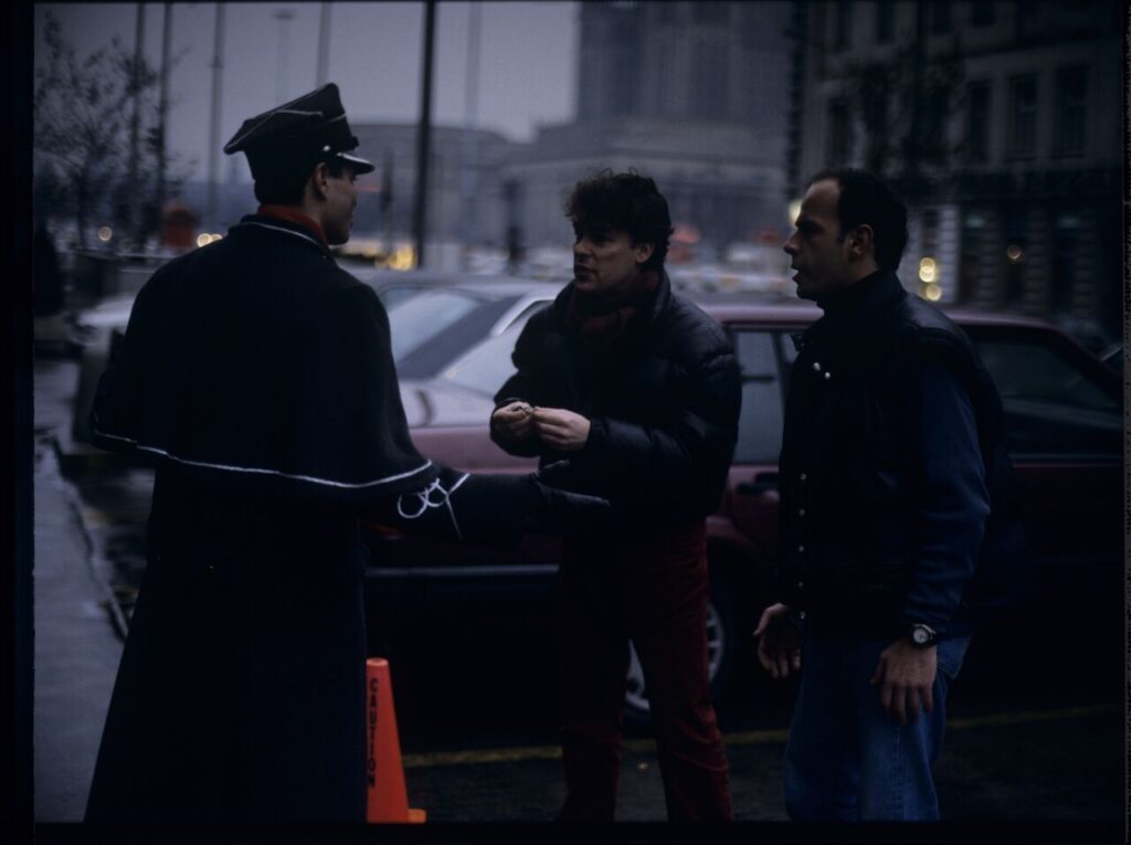 Passersby on a Warsaw street where Karol's car is parked.