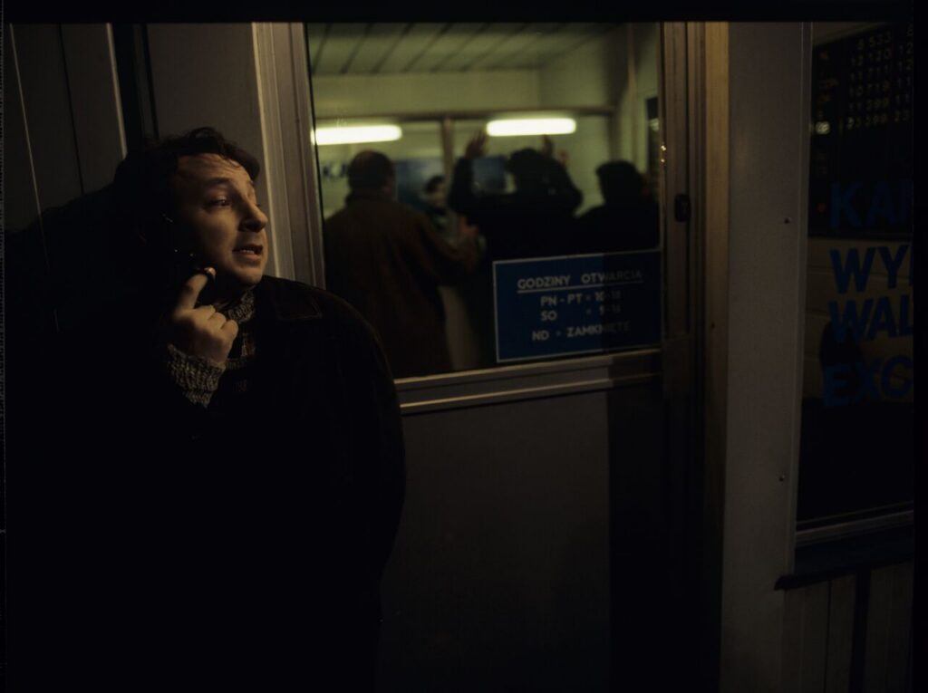 Karol (Zamachowski) as a security guard during a robbery at a currency exchange office. The scene did not appear in the film.