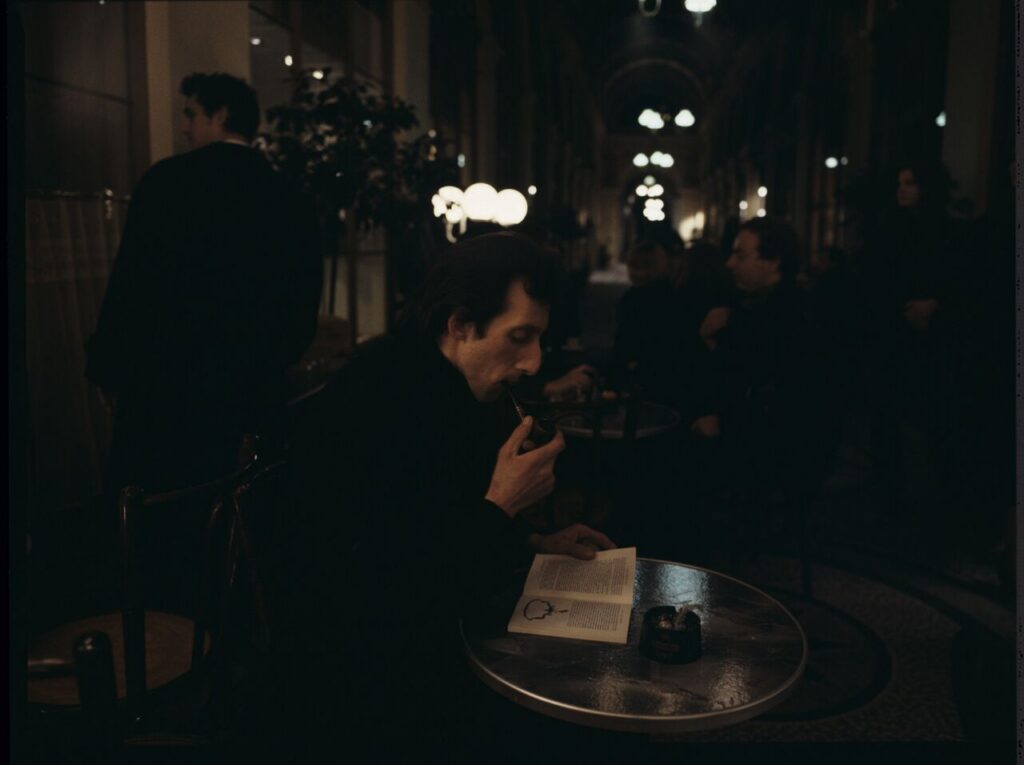 Parisian promenade, where, among elegant shops, there was an antique shop with an alabaster bust of a woman on display.