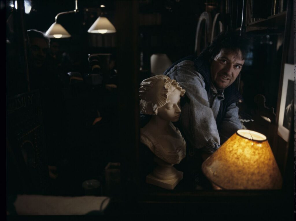 Parisian promenade, where, among elegant shops, there was an antique shop with an alabaster bust of a woman on display.