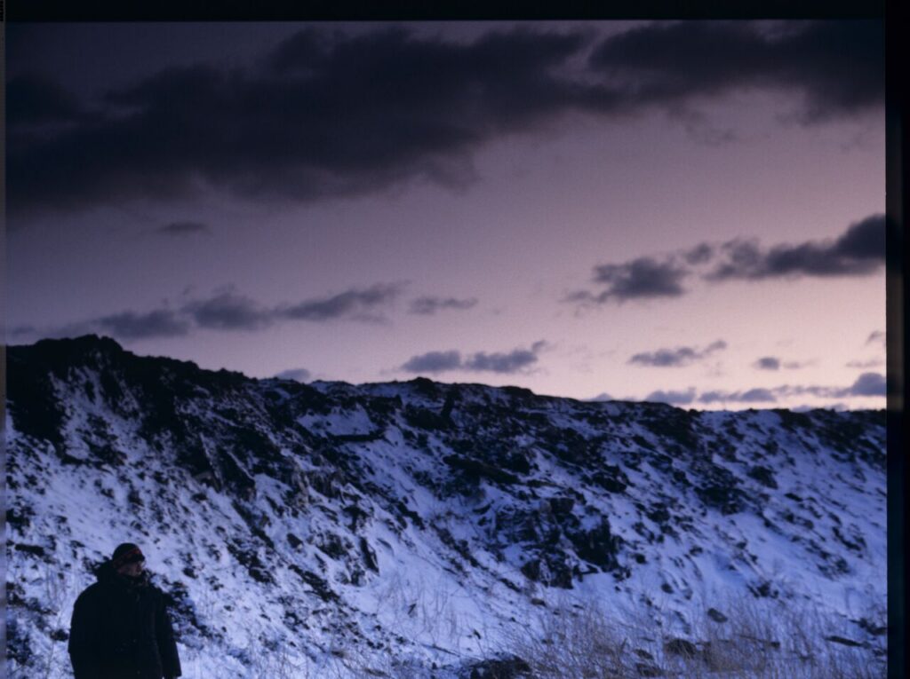 Krzysztof Kieślowski (director) on the set at a garbage dump.