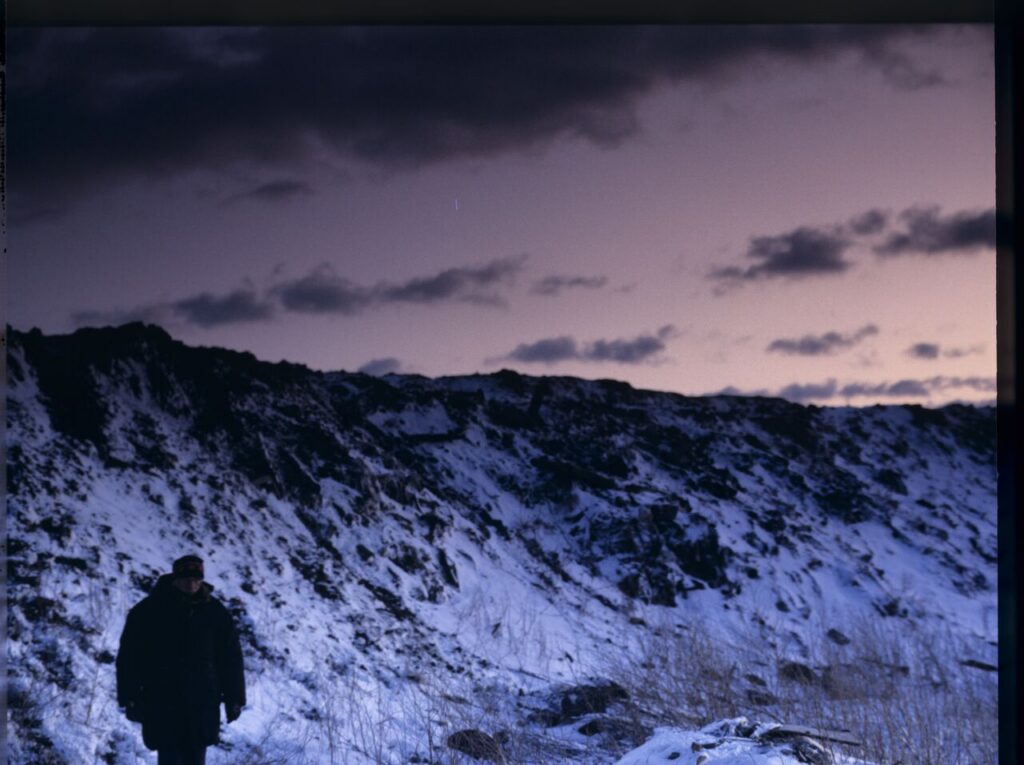 Krzysztof Kieślowski (director) on the set at a garbage dump.