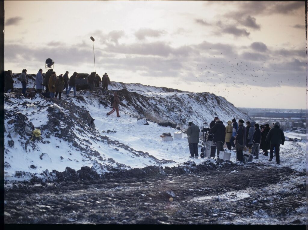 The crew on set at a garbage dump.