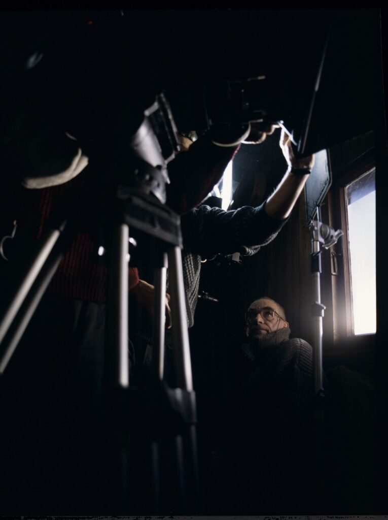 Krzysztof Kieślowski (director) on the set in the house of the farmer from whom Karol bought the land.
