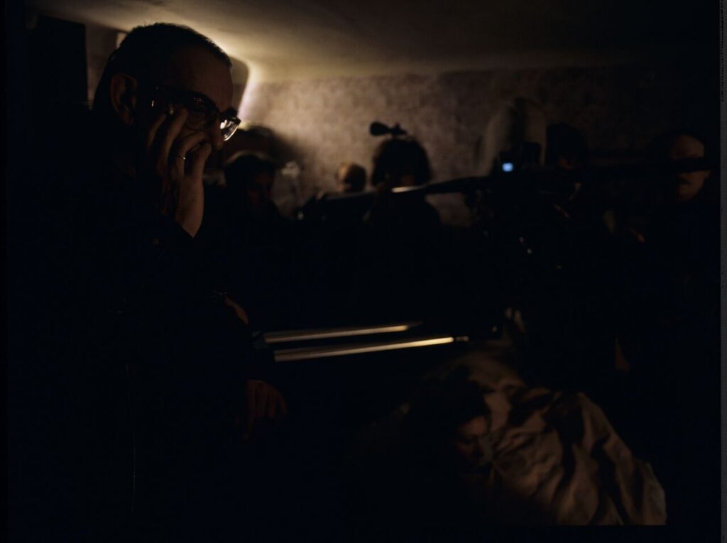 Krzysztof Kieślowski (director) on the set in the house of the farmer.