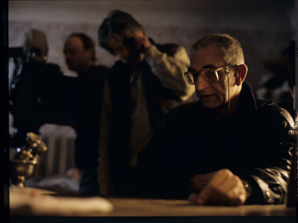 K. Kieślowski (director) and others on the set in the house of the farmer.