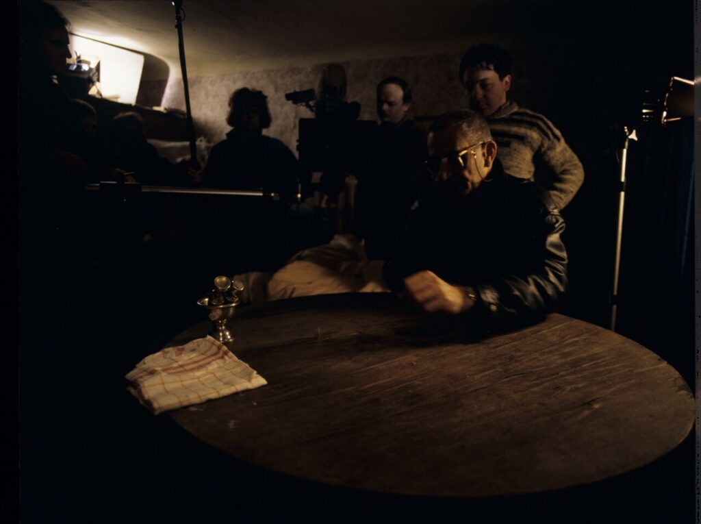 K. Kieślowski (director) and others on the set in the house of the farmer.