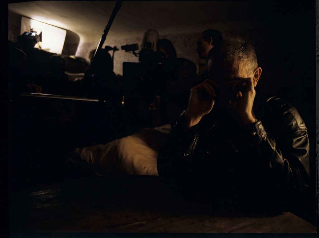 Krzysztof Kieślowski (director) on the set in the house of the farmer from whom Karol bought the land.