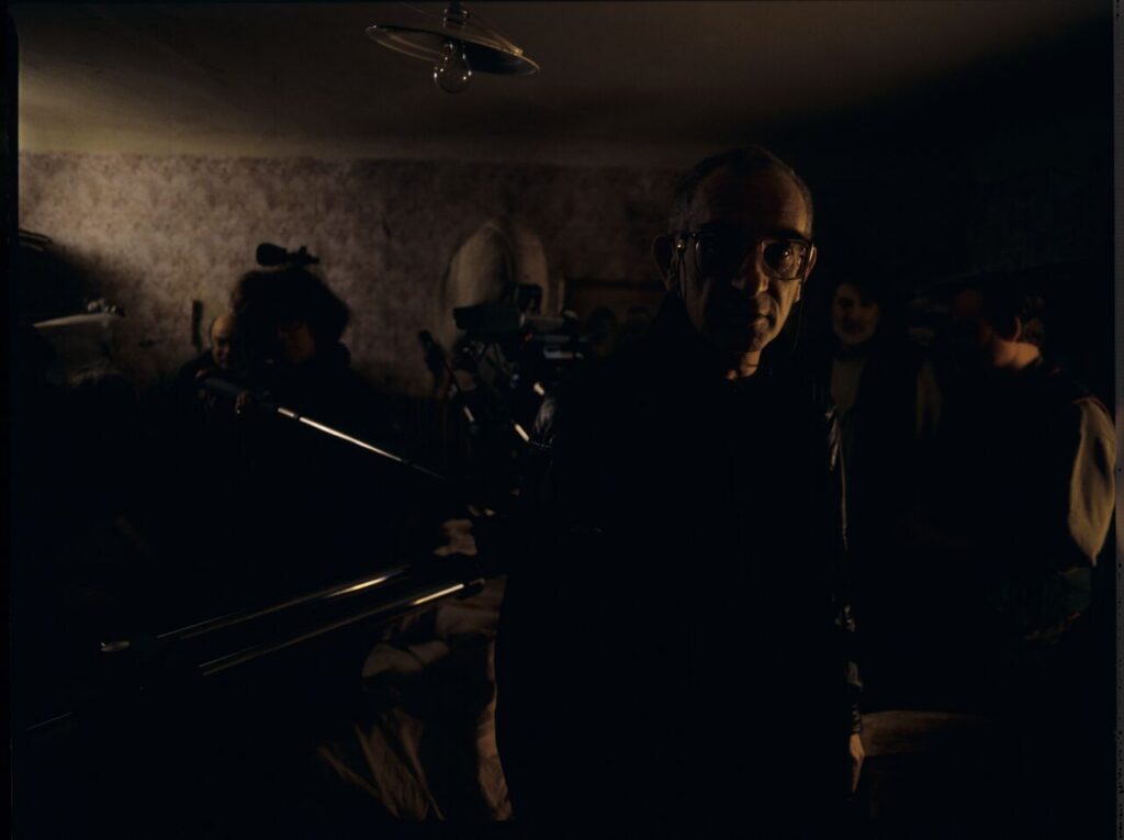 Krzysztof Kieślowski (director) on the set in the house of the farmer.