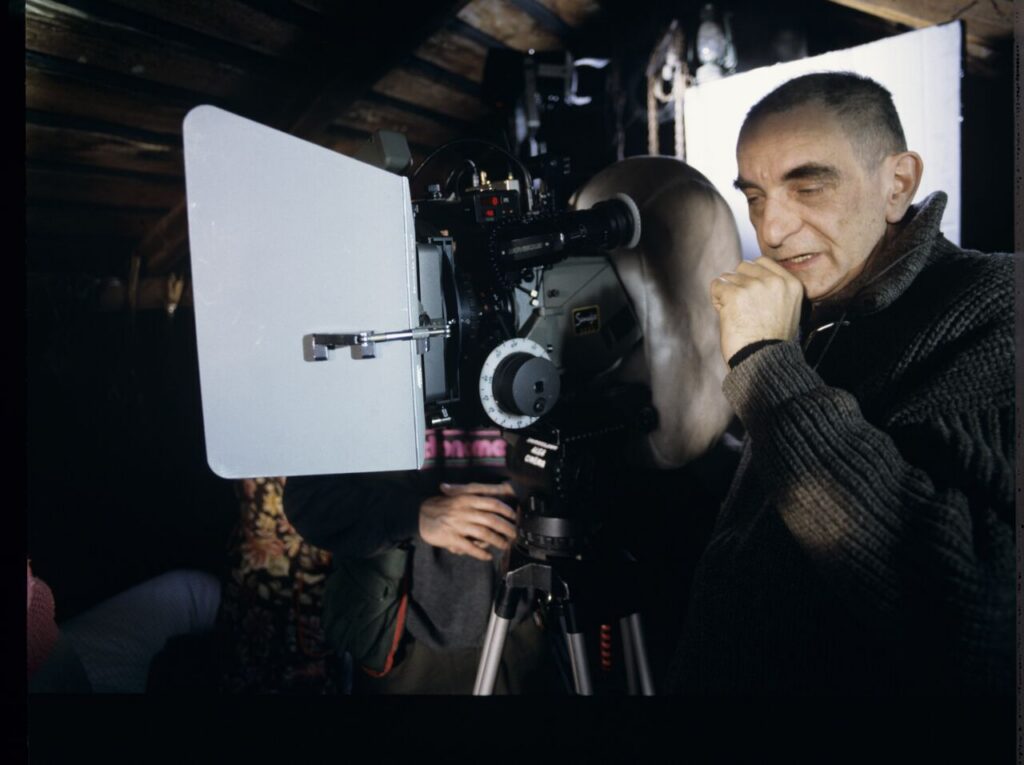 Krzysztof Kieślowski behind the camera on the set in the house of the farmer from whom Karol bought the land.