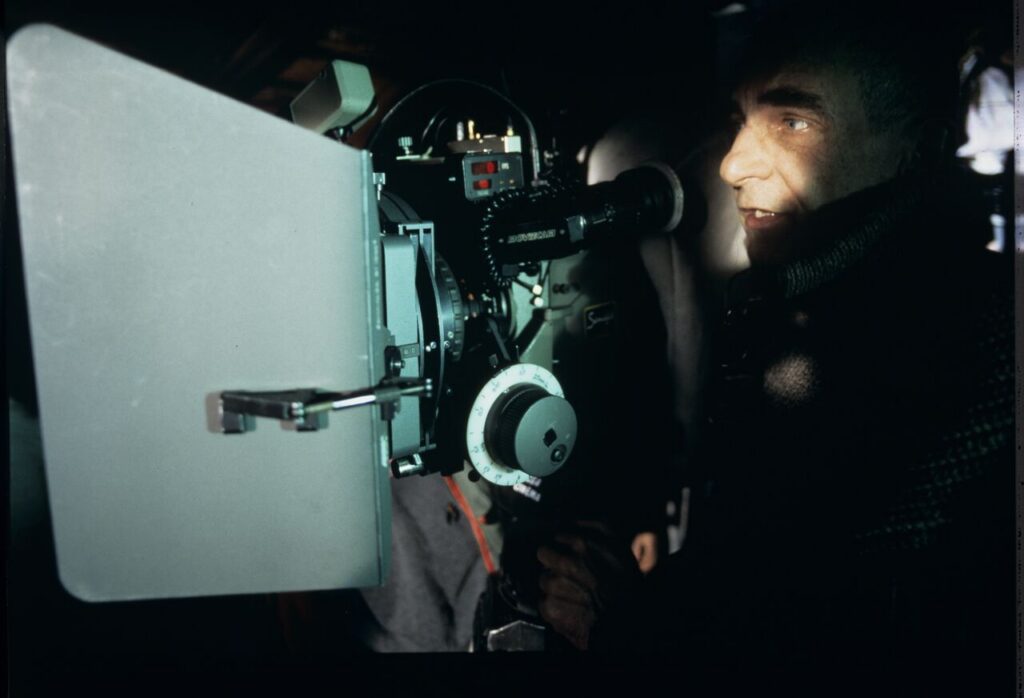 Krzysztof Kieślowski behind the camera on the set in the house of the farmer from whom Karol bought the land.