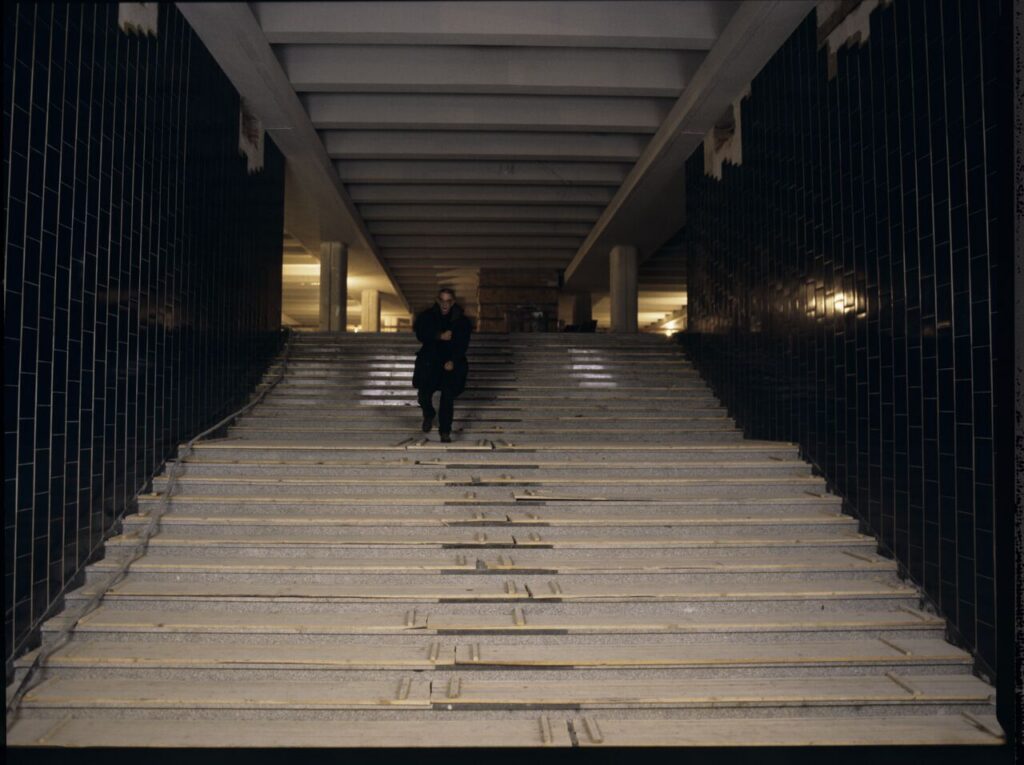 Krzysztof Kieslowski (director) on the stairs in the underground of the Warsaw metro.