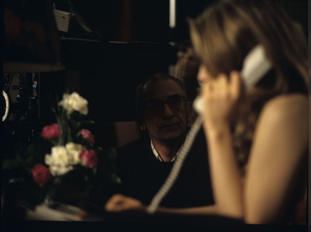 Krzysztof Kieślowski (director) and Julie Delpy (as Dominique) on set in a hotel room.