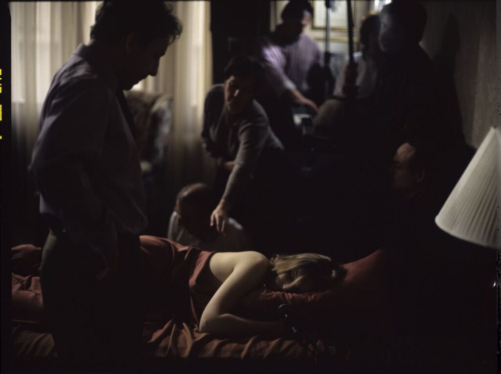 Karol (Zbigniew Zamachowski) watches his sleeping wife in the hotel room.
