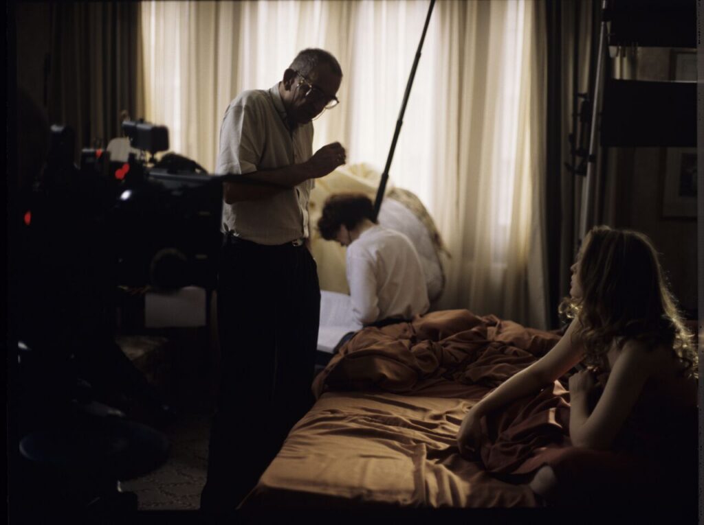 Krzysztof Kieślowski (director) gives instructions to Julie Delpy on the set in the hotel room.