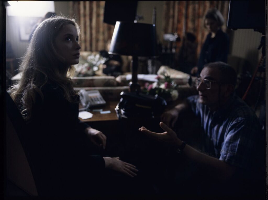 Krzysztof Kieślowski (director) gives instructions to Julie Delpy on the set in a hotel room.