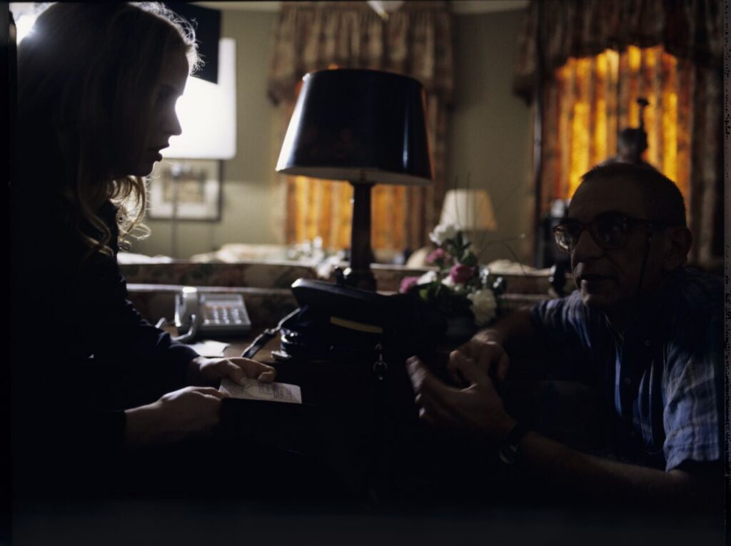 Krzysztof Kieślowski (director) gives instructions to Julie Delpy on the set in a hotel room.