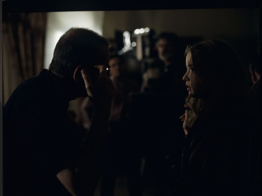 Krzysztof Kieślowski (director) gives instructions to Julie Delpy on the set in a hotel room.