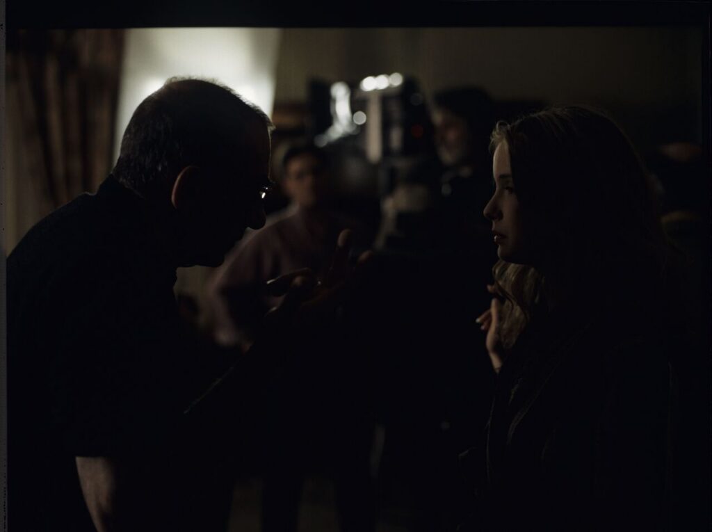 Krzysztof Kieślowski (director) talks to actress Julie Delpy (playing the role of Dominique) during a break between takes.