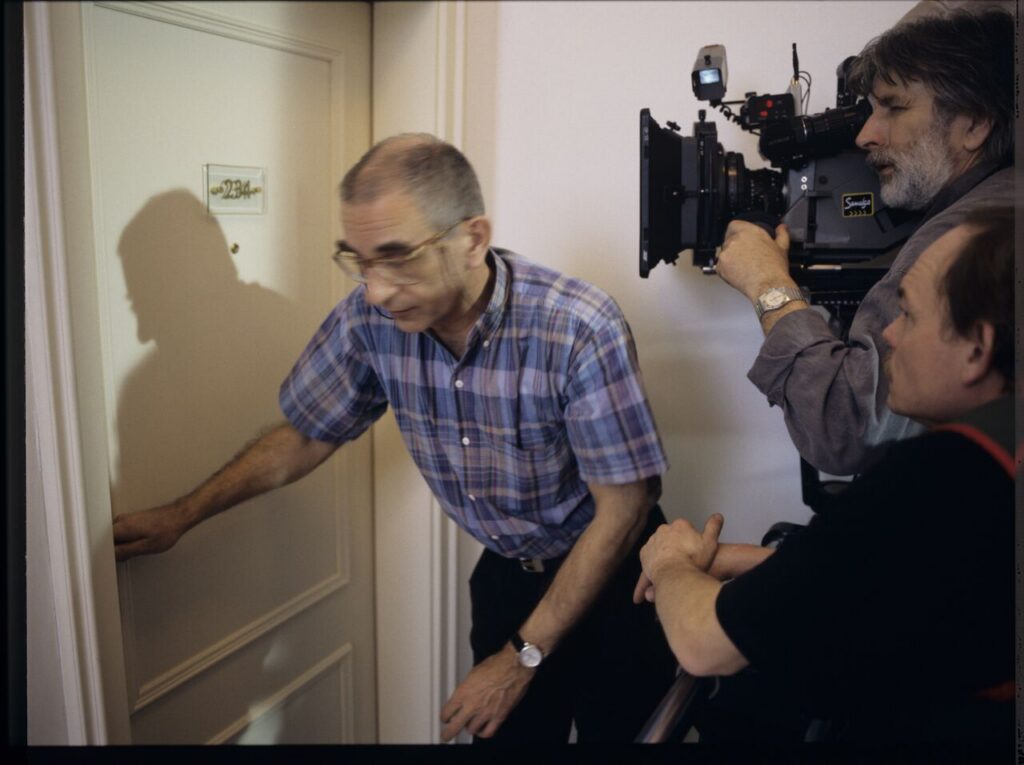 Krzysztof Kieślowski (director) and others in front of the door of the hotel room.