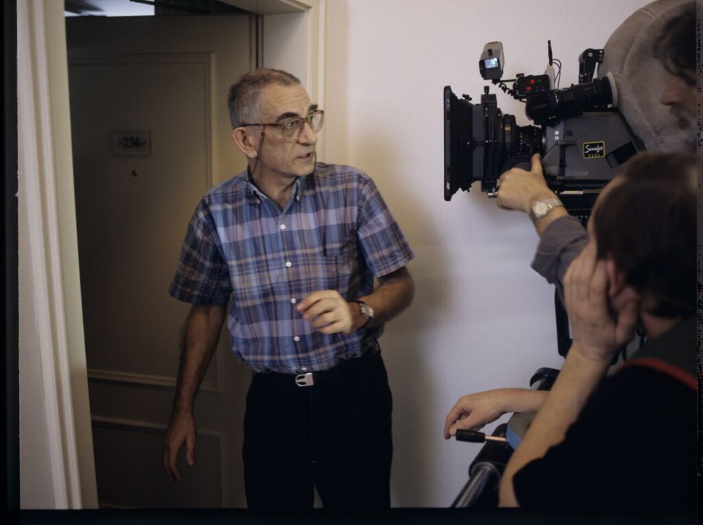 Krzysztof Kieślowski (director) and others in front of the door of the hotel room.