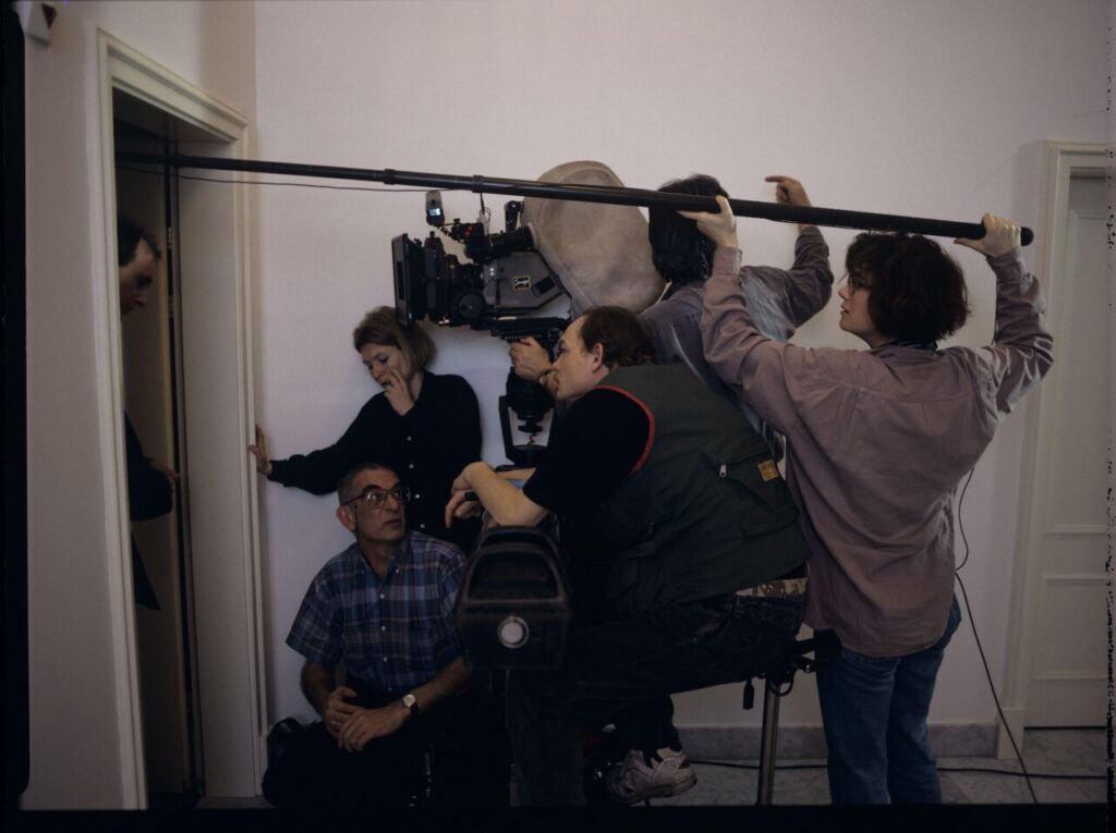 Krzysztof Kieślowski (director) and others in front of the door of the hotel room.