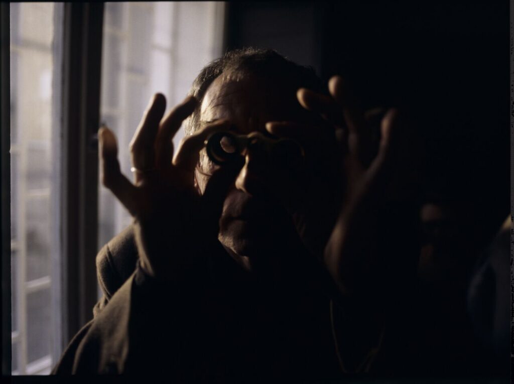 Krzysztof Kieślowski (director) on the set with binoculars.