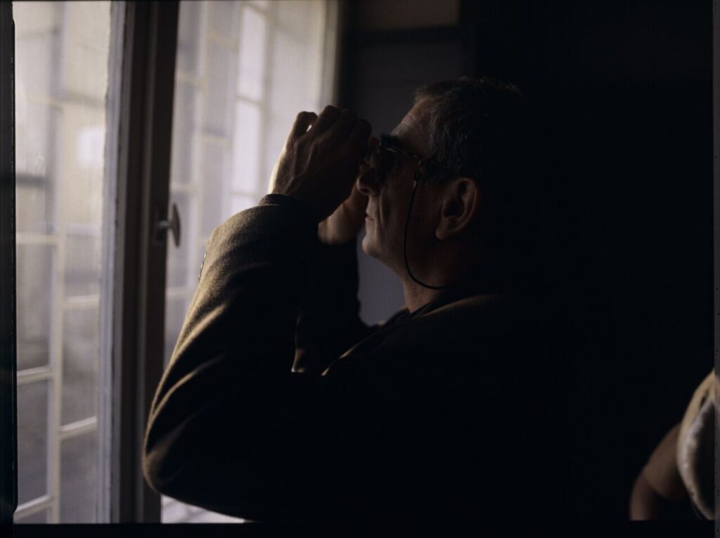 Krzysztof Kieślowski (director) on the set with binoculars.