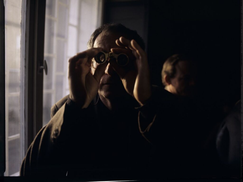 Krzysztof Kieślowski (director) on the set with binoculars.