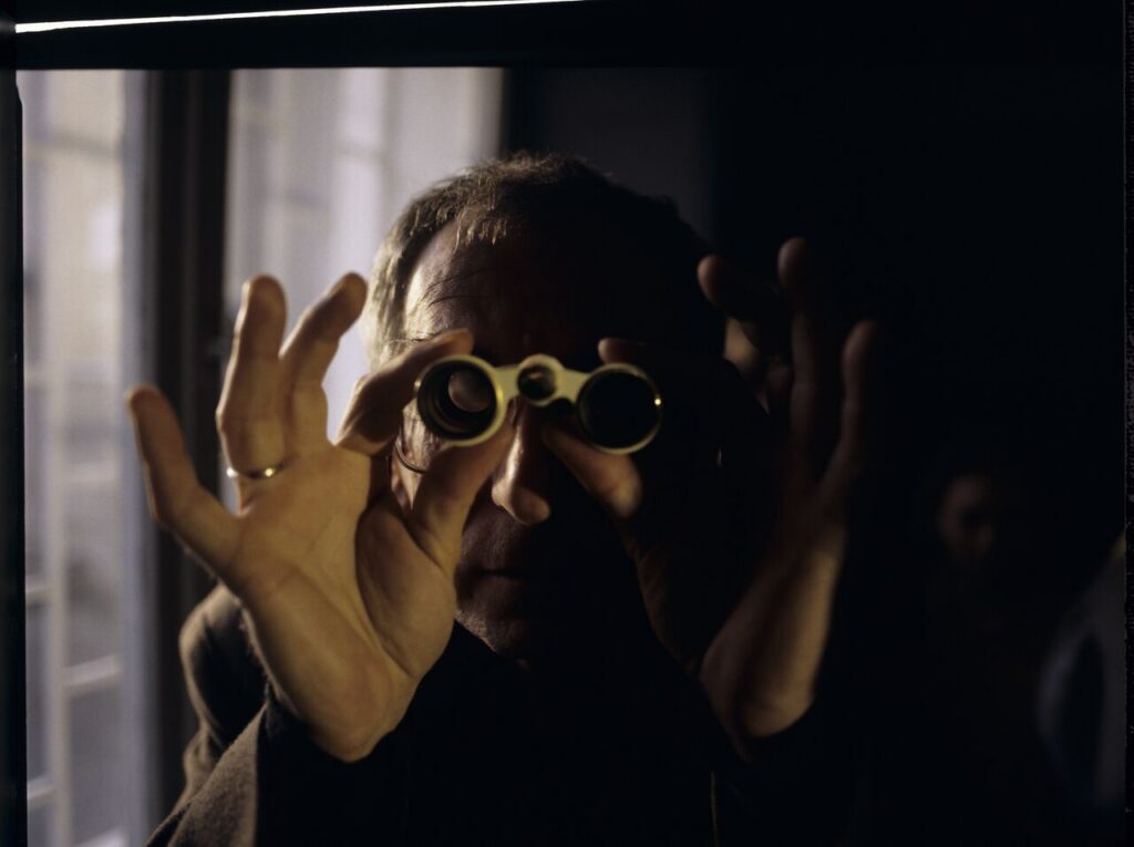 Krzysztof Kieślowski (director) on the set with binoculars.