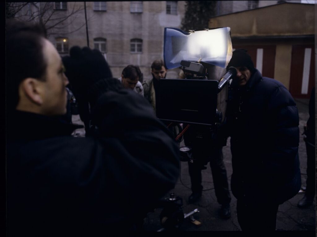 Filming a scene near the walls of the prison building where Karol's wife, Dominique, is serving a sentence.