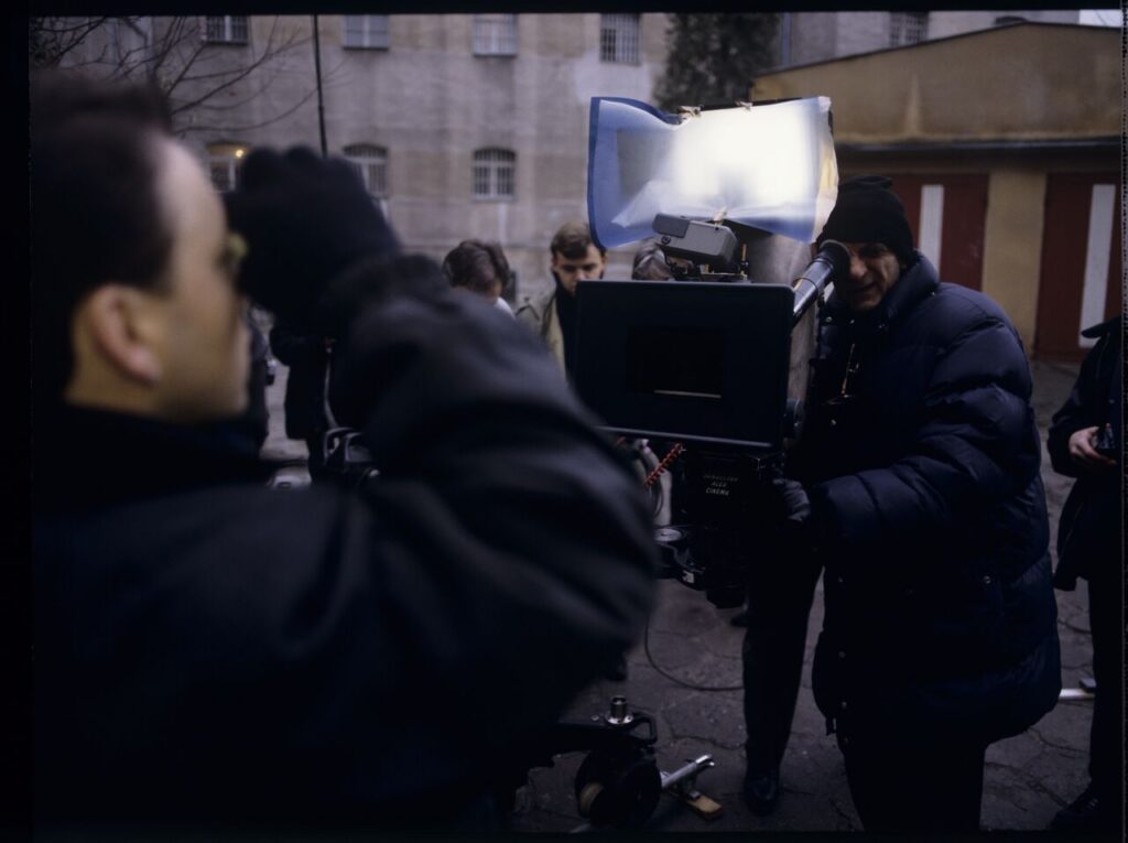 Filming a scene near the walls of the prison building where Karol's wife, Dominique, is serving a sentence.