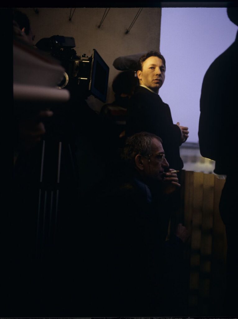 Zbigniew Zamachowski (who plays Karol) and Krzysztof Kieślowski (director) surrounded by the crew on the set.