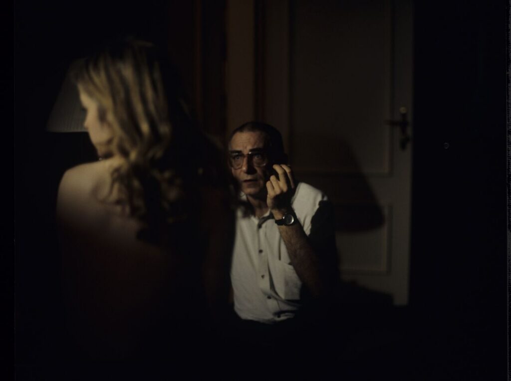 Krzysztof Kieślowski (director) gives directions to actress Julie Delpy (playing Dominique) in a hotel room.