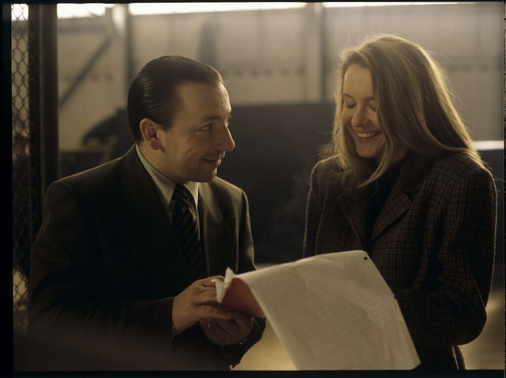 Karol (Zbigniew Zamachowski) taking to one of the workers in his new company.