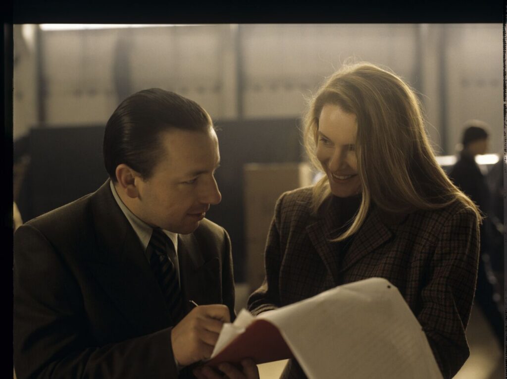 Karol (Zbigniew Zamachowski) taking to one of the workers in his new company.