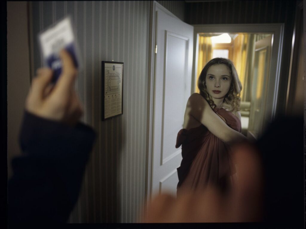 Dominique (Julie Delpy) lets the police into her hotel suite.