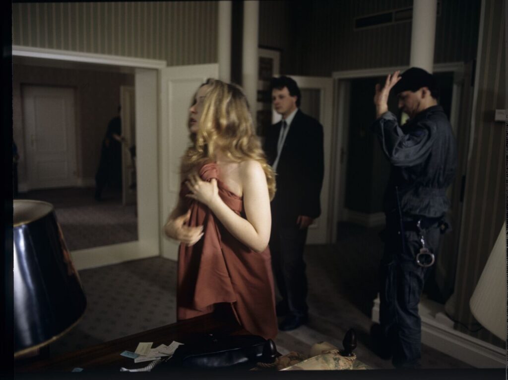 Dominique (Julie Delpy) lets the police into her hotel suite.