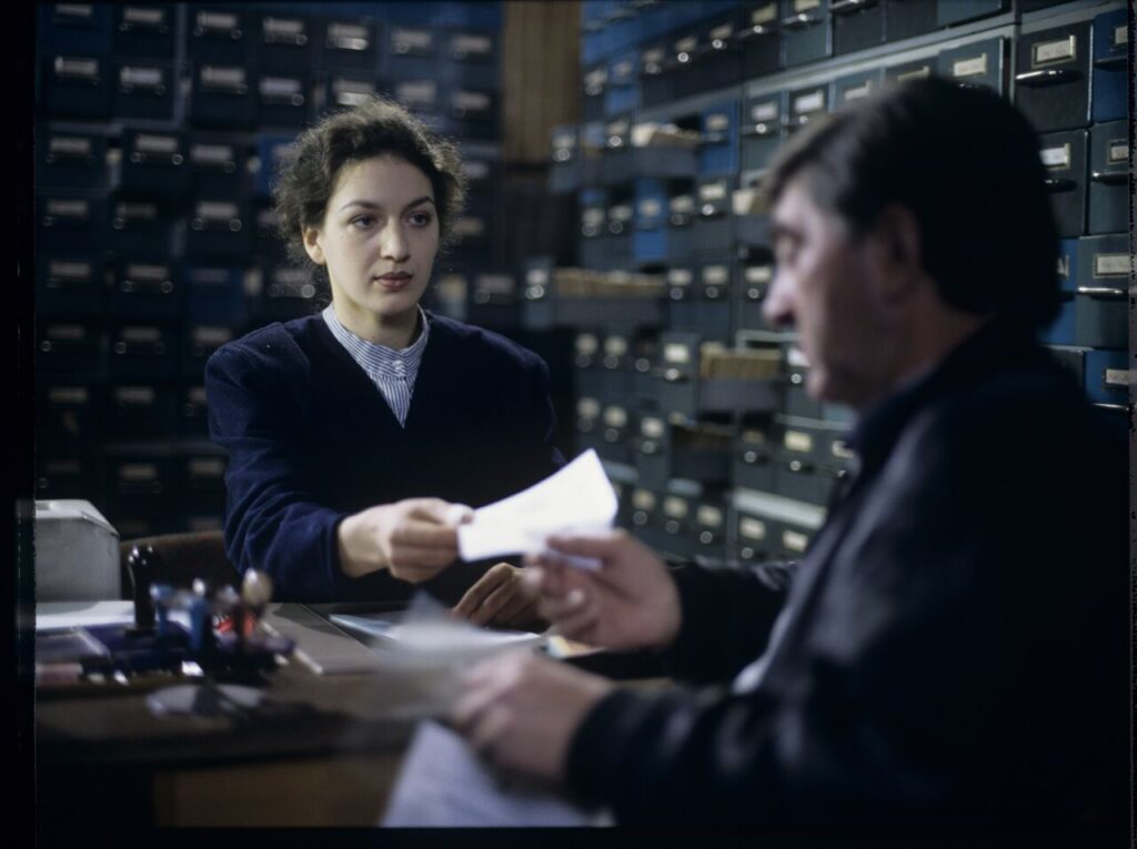 Mr. Bronek, Karol's driver is giving Karol (Zbigniew Zamachowski) documents confirming his death.