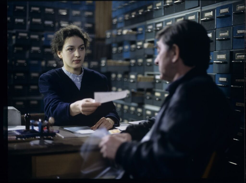 Mr. Bronek, Karol's driver is giving Karol (Zbigniew Zamachowski) documents confirming his death.