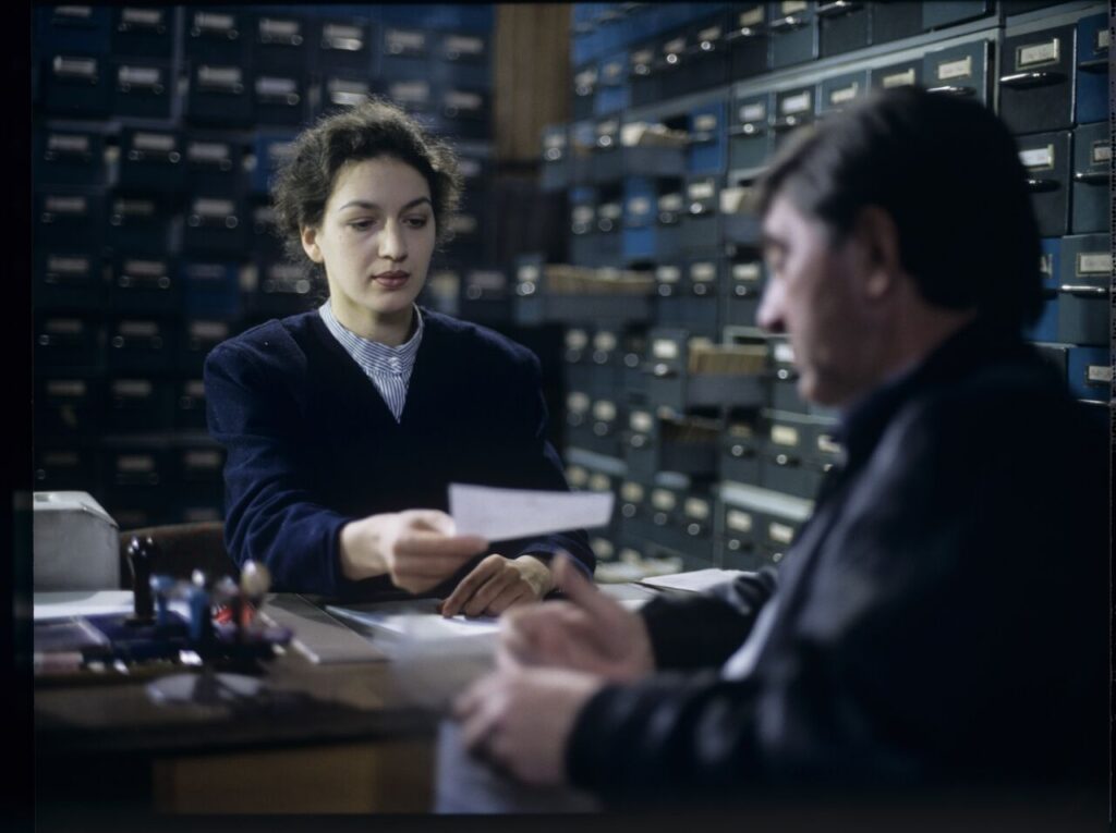 Mr. Bronek, Karol's driver is giving Karol (Zbigniew Zamachowski) documents confirming his death.