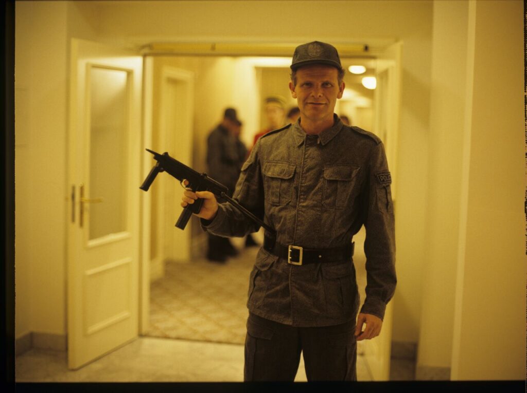 Roman Gren (translator) is an extra in the photo as a police officer in the scene where Dominique is arrested.