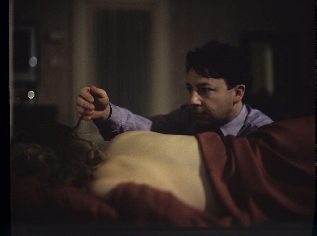 After spending the night together, Karol (Zbigniew Zamachowski) watches Dominique (Julie Delpy) sleep.