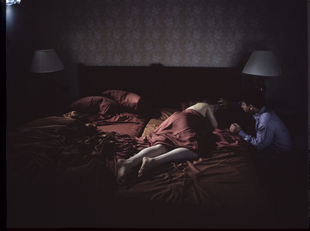 After spending the night together, Karol (Zbigniew Zamachowski) watches Dominique (Julie Delpy) sleep.